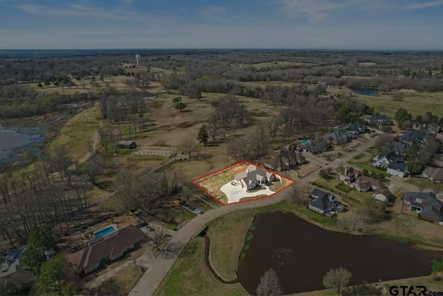 an aerial view of a house with a yard
