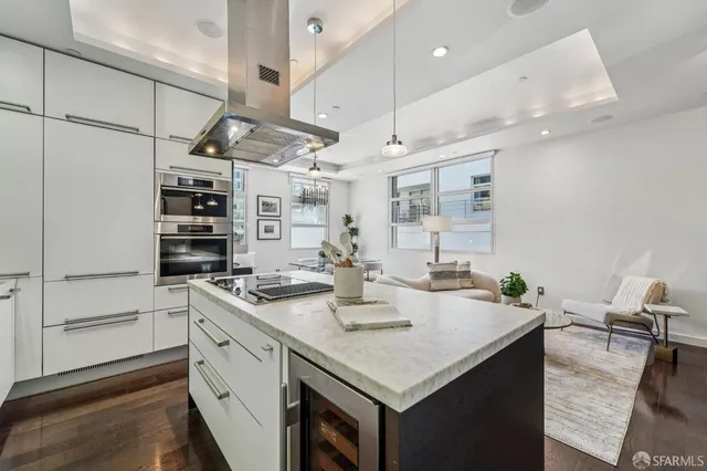 a kitchen with a sink stainless steel appliances furniture cabinets and a counter top space