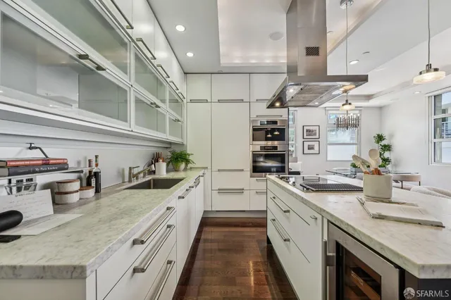 a large kitchen with stainless steel appliances granite countertop a lot of counter space