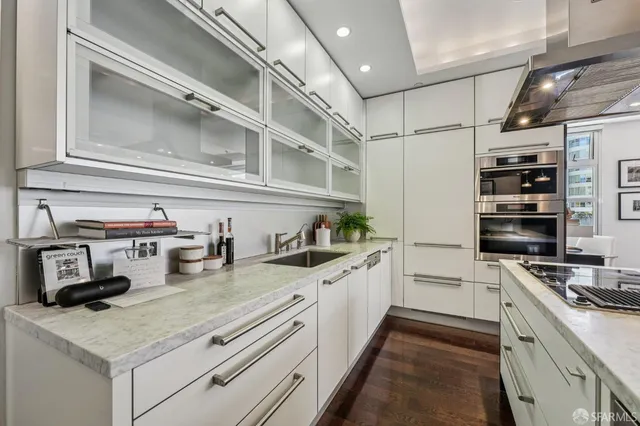a kitchen with stainless steel appliances granite countertop a sink and cabinets