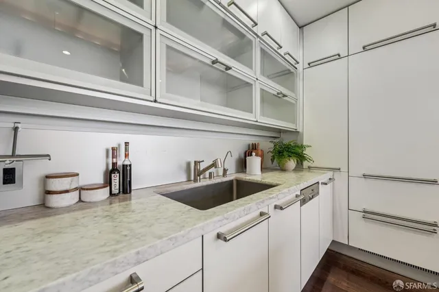 a kitchen with a sink and a white cabinets