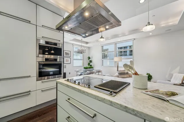 a kitchen with a sink stainless steel appliances and lots of wooden cabinets