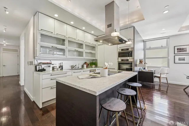 a kitchen with a table chairs stove and cabinets