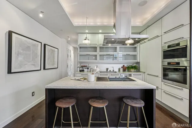a kitchen with stainless steel appliances a sink and a refrigerator