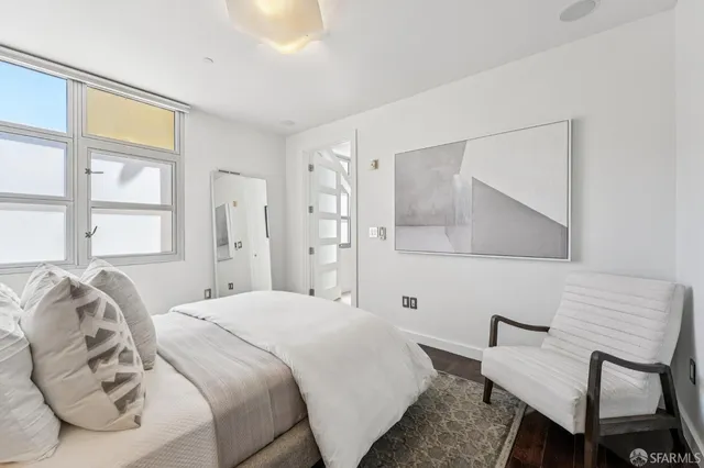 a bedroom with a bed and a couch