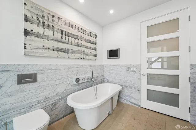 a bathroom with a toilet a sink and a shower