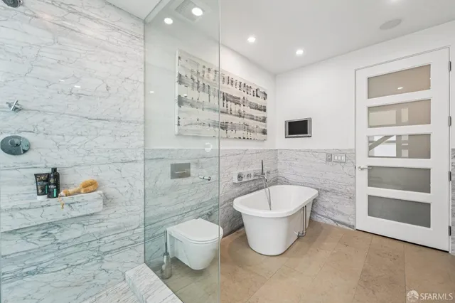 a bathroom with a toilet sink and shower