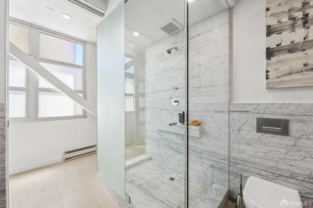 a bathroom with a shower and toilet