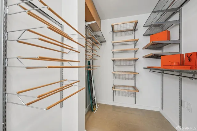 a view of walk in closet with empty racks