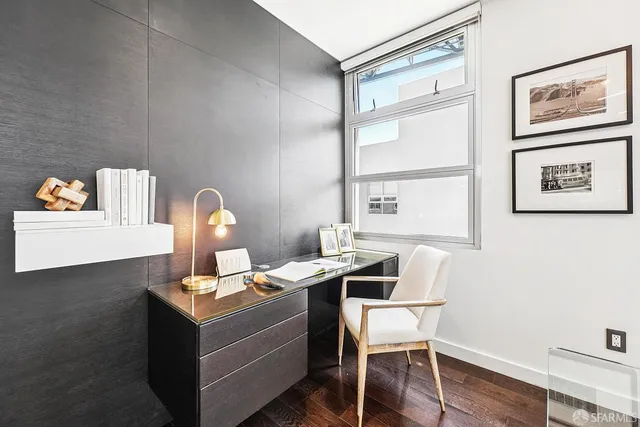 a room with a table chairs and wooden floor