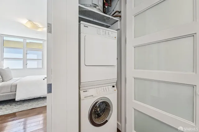a view of a bedroom with washer and dryer