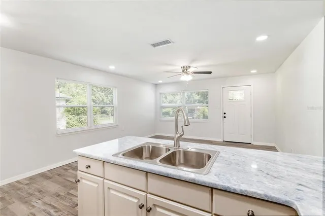 a kitchen with a sink and chandelier
