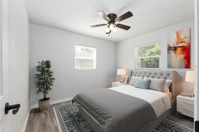 a bedroom with bed and a potted plant