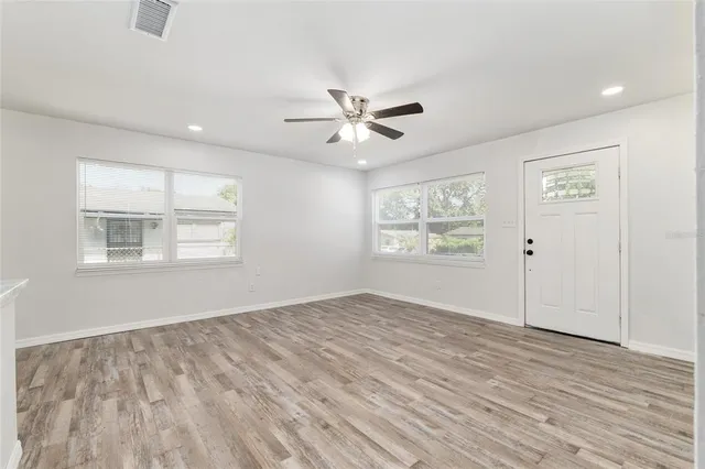 wooden floor in an empty room with a window