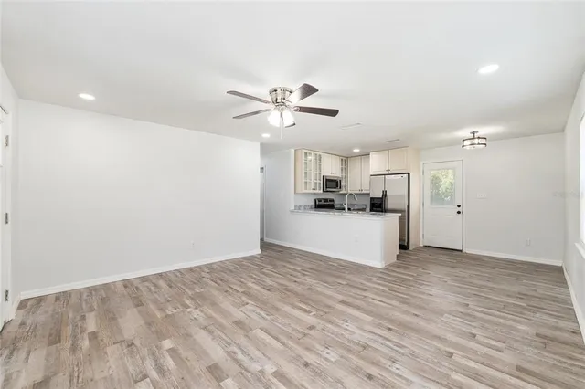 a view of a kitchen with a sink and a refrigerator