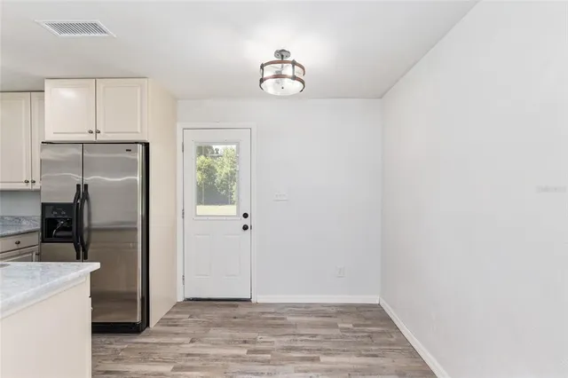 a view of a kitchen with dishwasher and refrigerator