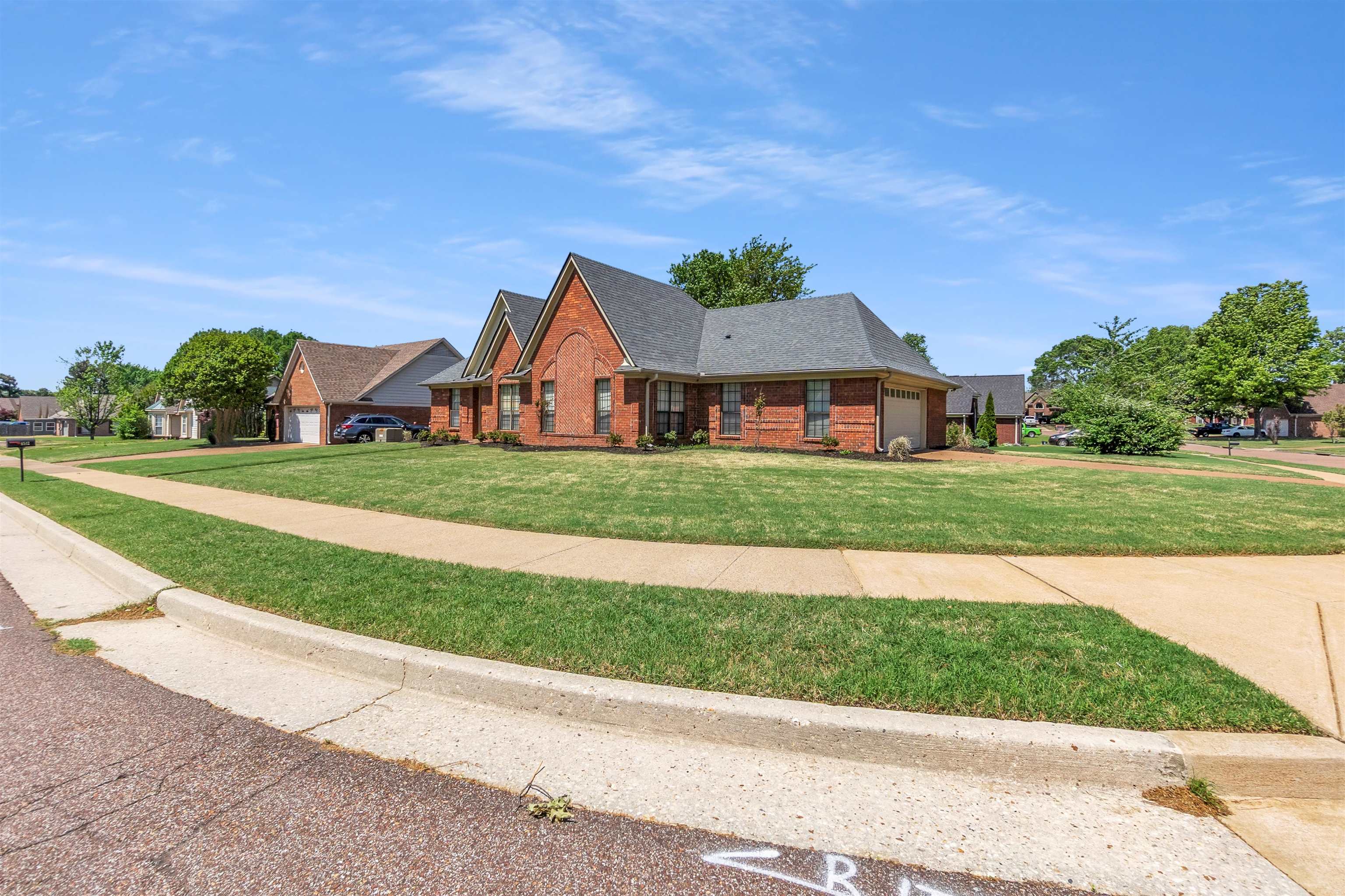6512 Birch Mill Road Bartlett, TN 38135 - Photo 2 of 25 View of front of house featuring a garage, brick siding, a front yard, roof with shingles, and driveway