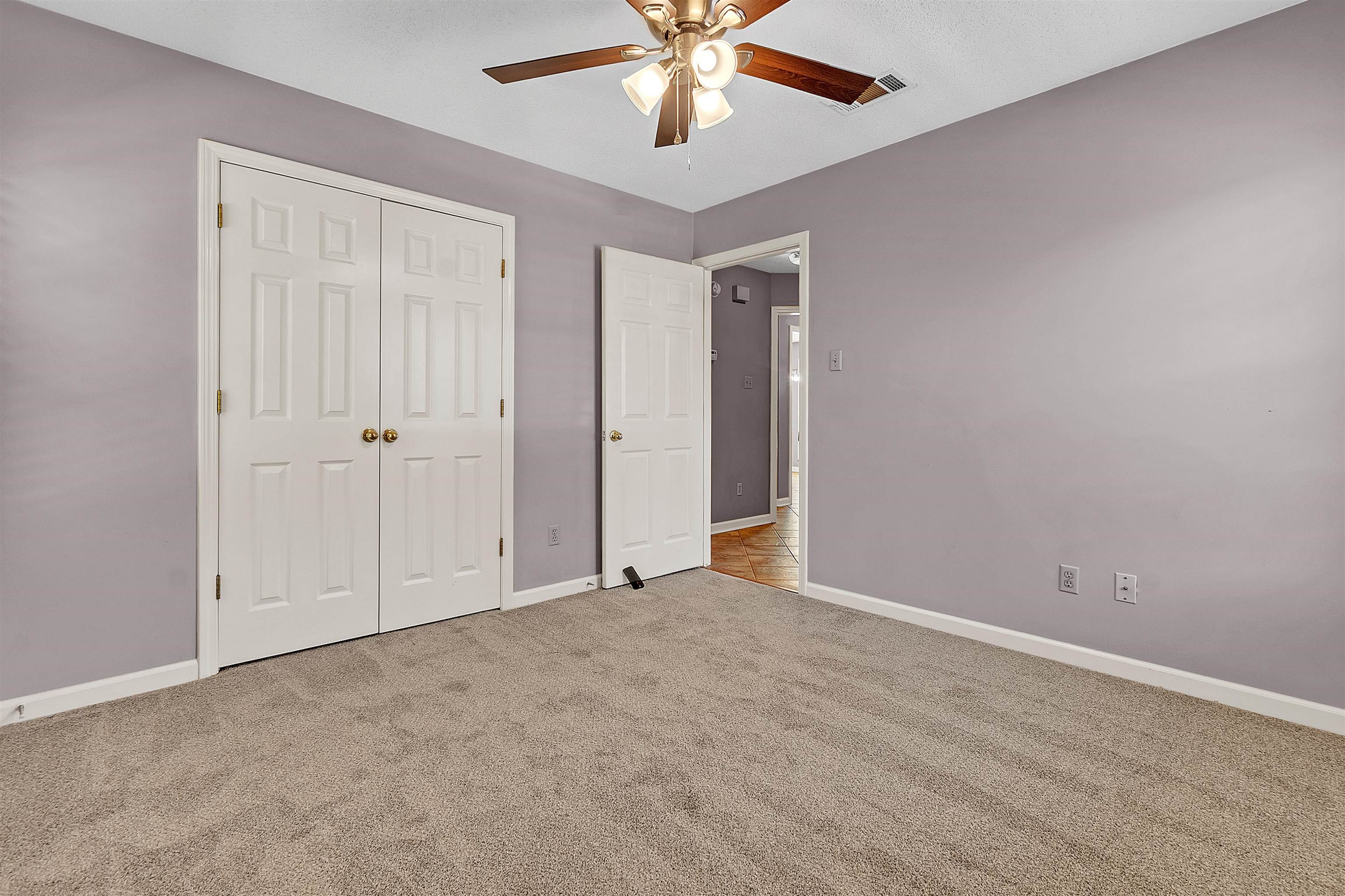 6512 Birch Mill Road Bartlett, TN 38135 - Photo 23 of 25 Unfurnished bedroom with light colored carpet, ceiling fan, and a closet