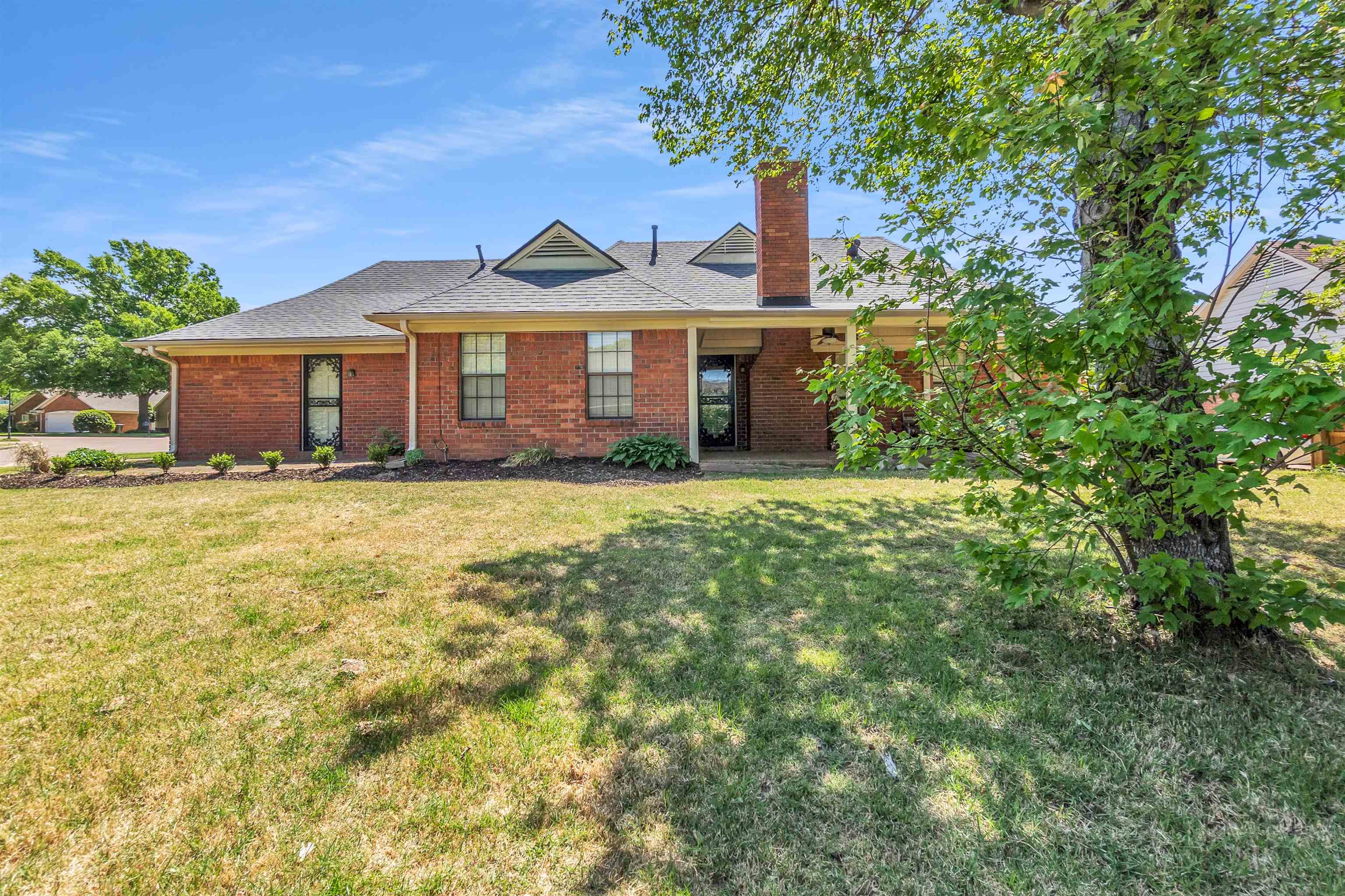 6512 Birch Mill Road Bartlett, TN 38135 - Photo 25 of 25 View of front of house featuring a chimney, a front lawn, brick siding, and roof with shingles