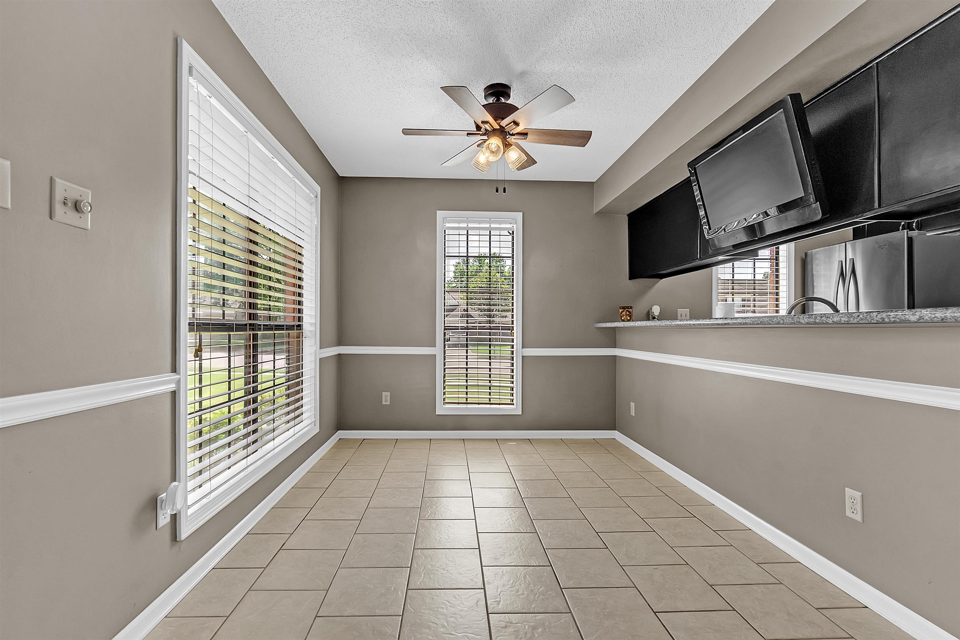 6512 Birch Mill Road Bartlett, TN 38135 - Photo 9 of 25 Unfurnished dining area with a ceiling fan, a textured ceiling, and light tile patterned floors