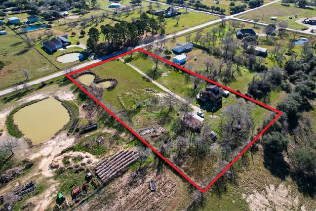 an aerial view of a houses with a yard