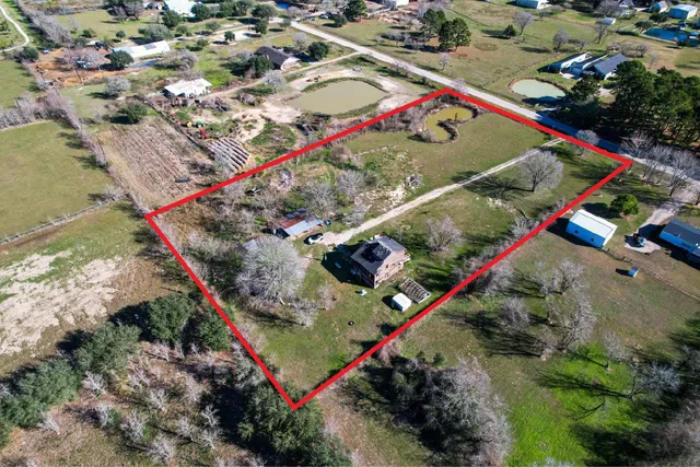 an aerial view of a house with a lake view
