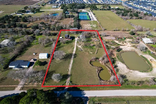 a view of swimming pool with a garden and plants