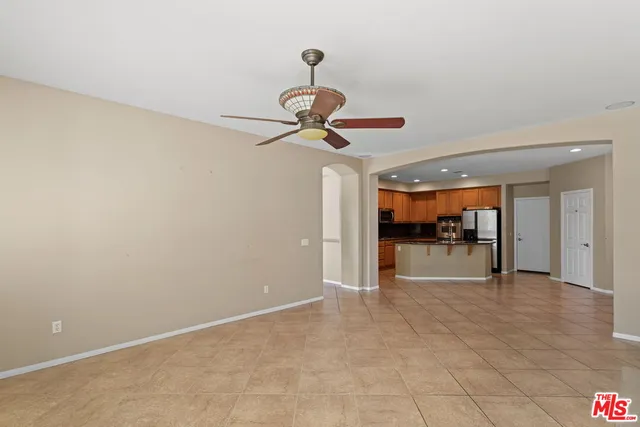 a view of a livingroom with wooden floor and a ceiling fan