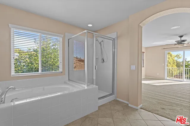 a spacious bathroom with a bathtub and a shower