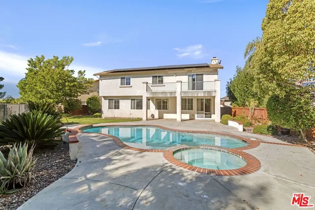 a front view of a house with a swimming pool