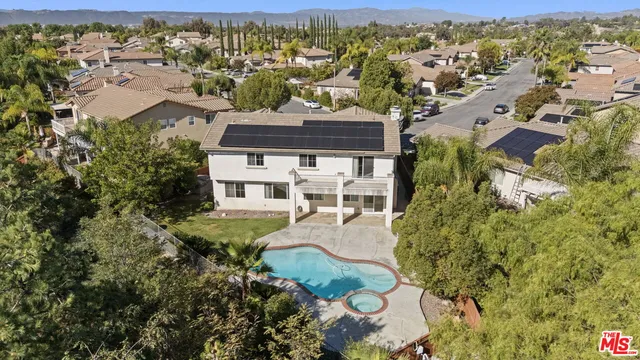 an aerial view of residential house with outdoor space and mountain view