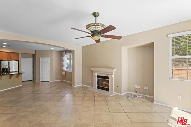 a view of an empty room with a fireplace and a window