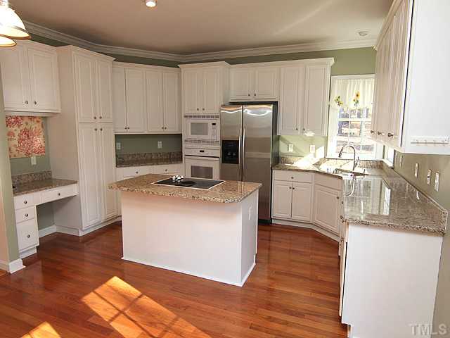 6820 Cool Pond Road Raleigh, NC 27613 - Photo 4 of 12 a kitchen with stainless steel appliances granite countertop a refrigerator a stove a sink and a microwave