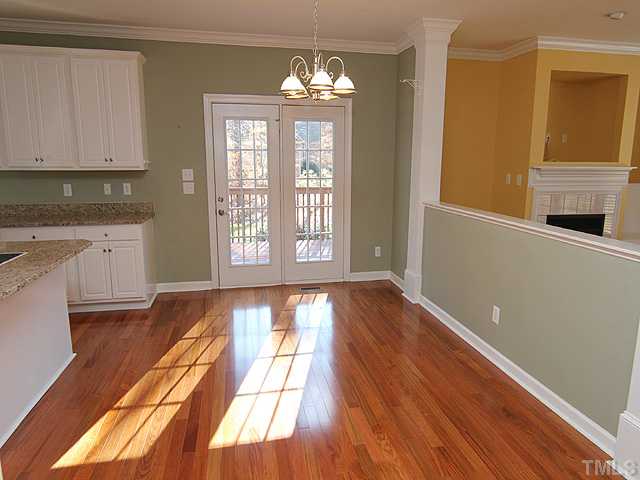 6820 Cool Pond Road Raleigh, NC 27613 - Photo 5 of 12 a view of an empty room with wooden floor and a window