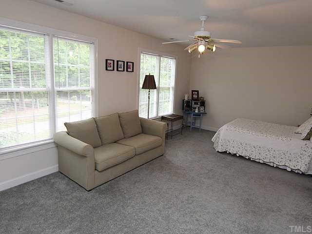 6820 Cool Pond Road Raleigh, NC 27613 - Photo 8 of 12 a living room with furniture and a large window