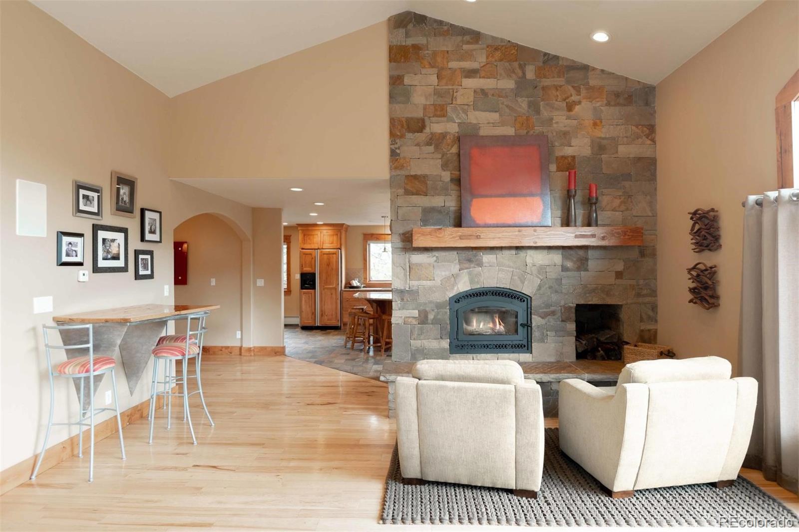 33231 Meadow Mountain Road Evergreen, CO 80439 - Photo 12 of 40 a living room with furniture and a fireplace