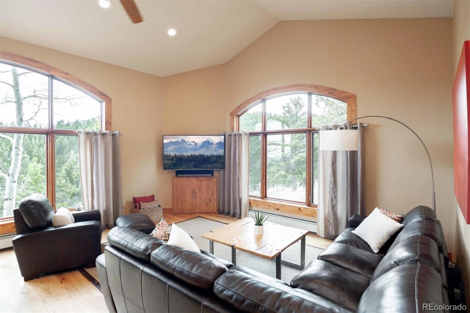 33231 Meadow Mountain Road Evergreen, CO 80439 - Photo 13 of 40 a living room with furniture and a large window