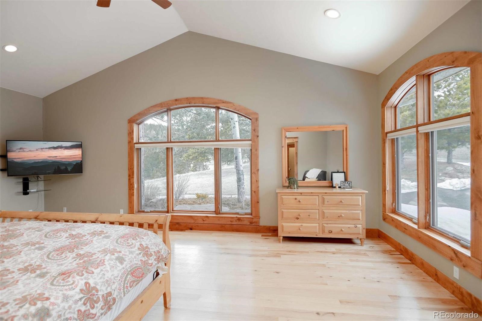 33231 Meadow Mountain Road Evergreen, CO 80439 - Photo 17 of 40 a bedroom with a bed and a large window