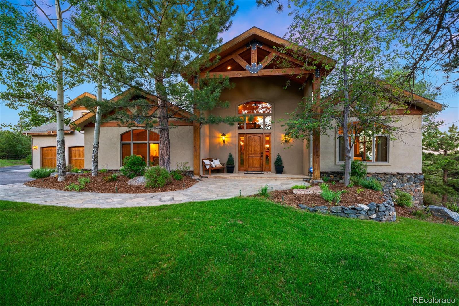 33231 Meadow Mountain Road Evergreen, CO 80439 - Photo 2 of 40 a front view of a house with a yard