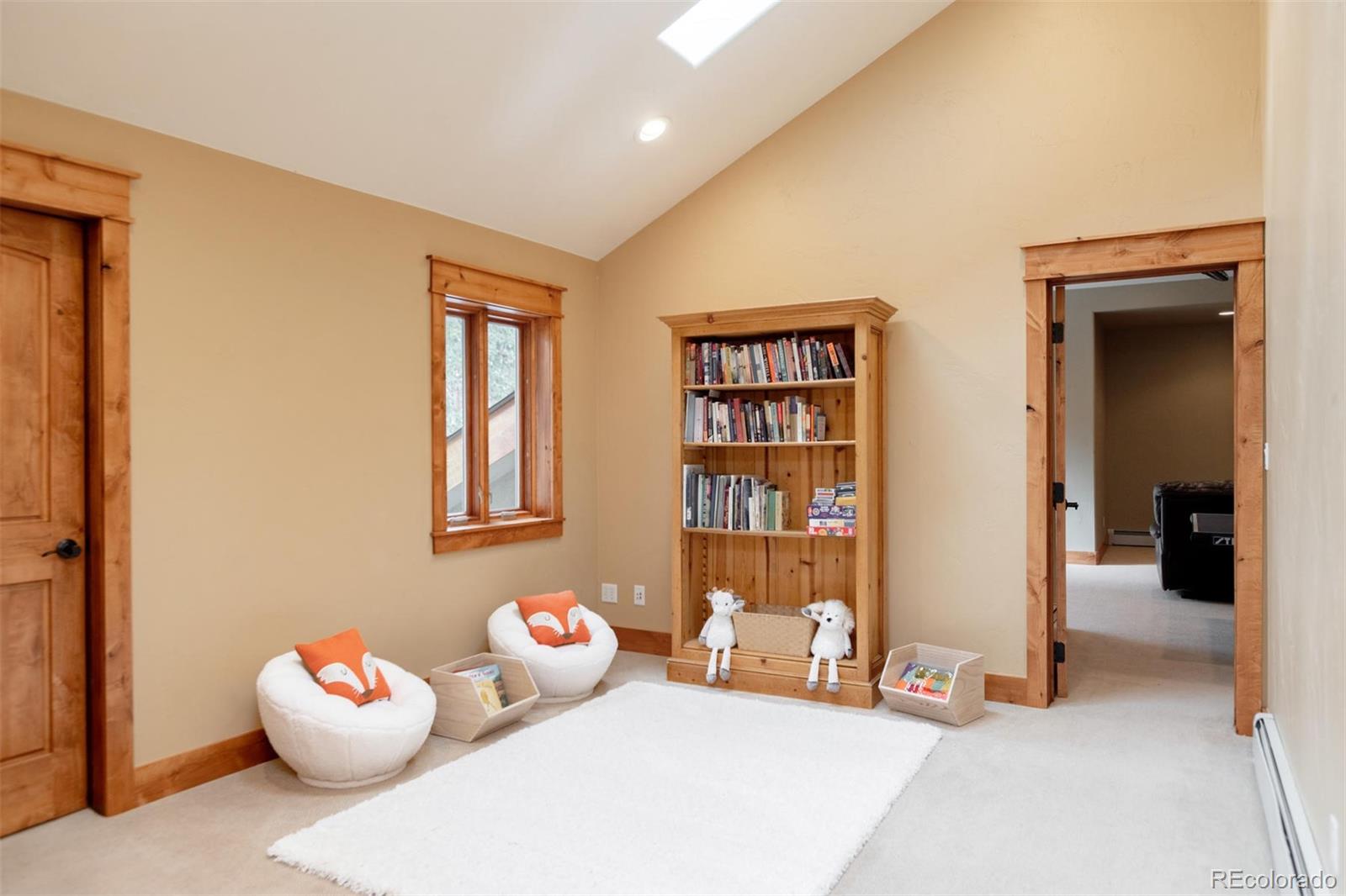 33231 Meadow Mountain Road Evergreen, CO 80439 - Photo 27 of 40 a bedroom with furniture and a potted plant