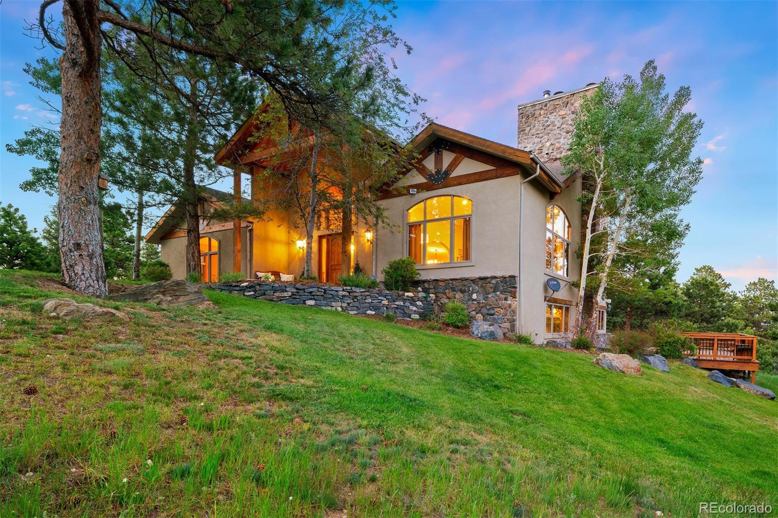 33231 Meadow Mountain Road Evergreen, CO 80439 - Photo 3 of 40 a front view of a house with garden