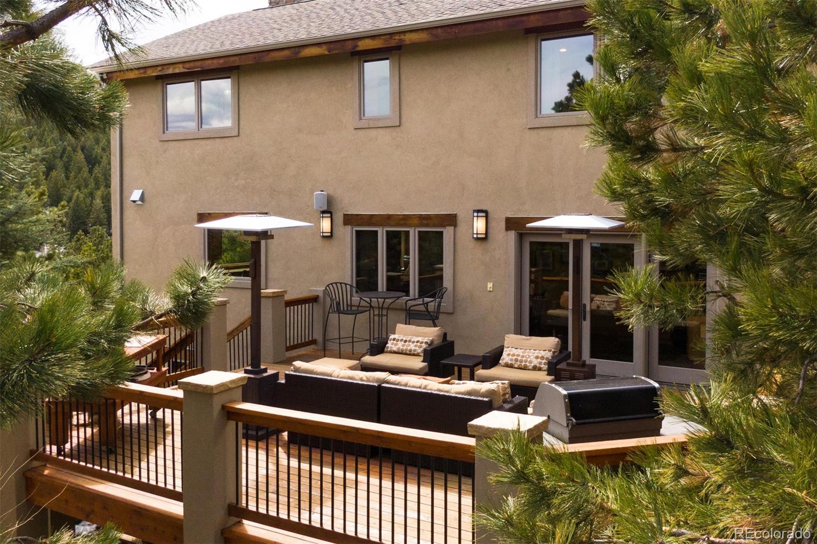 33231 Meadow Mountain Road Evergreen, CO 80439 - Photo 34 of 40 a view of a house with pool and chairs