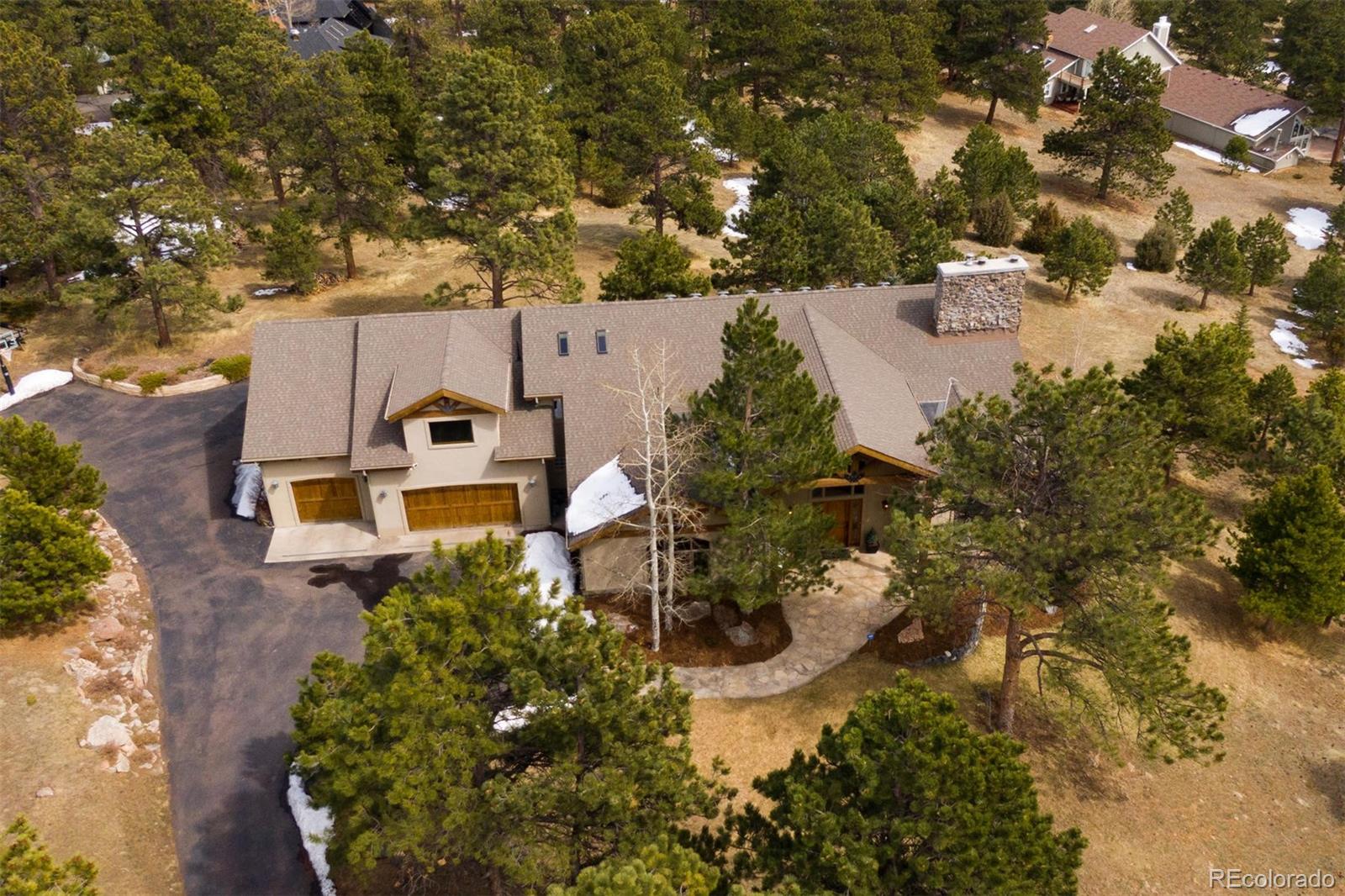 33231 Meadow Mountain Road Evergreen, CO 80439 - Photo 36 of 40 an aerial view of a house with a yard and trees all around