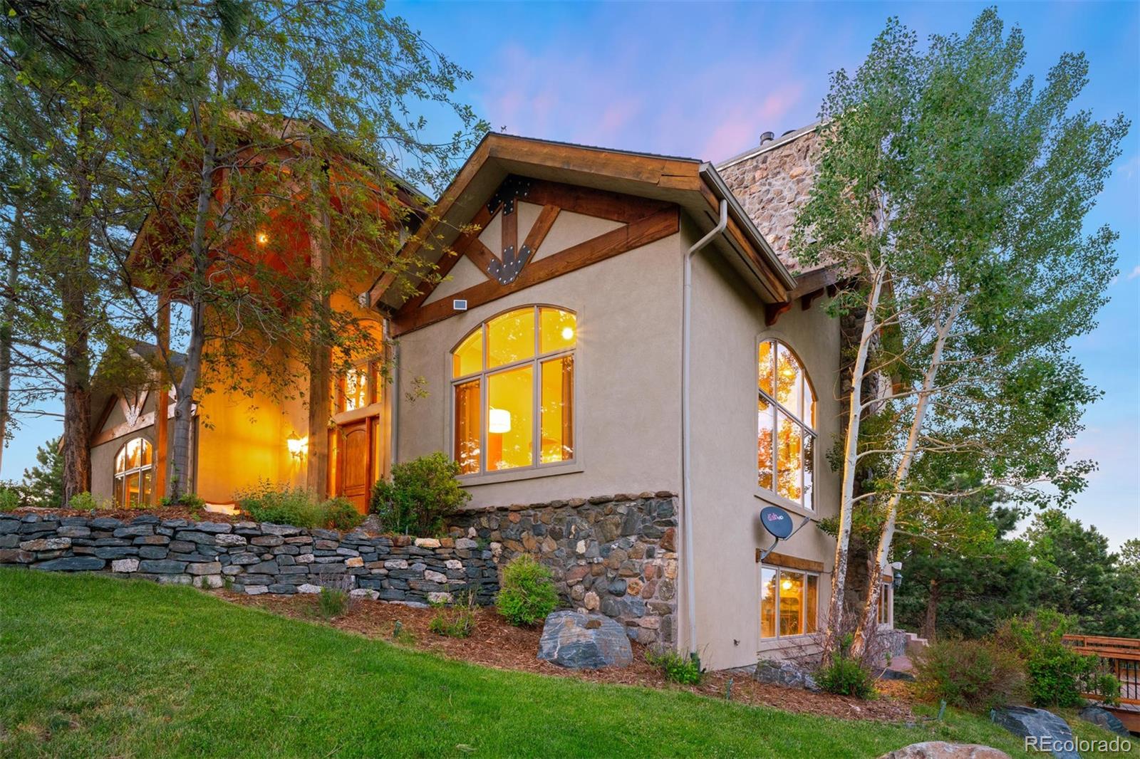 33231 Meadow Mountain Road Evergreen, CO 80439 - Photo 37 of 40 a view of a house with a small yard and a large tree