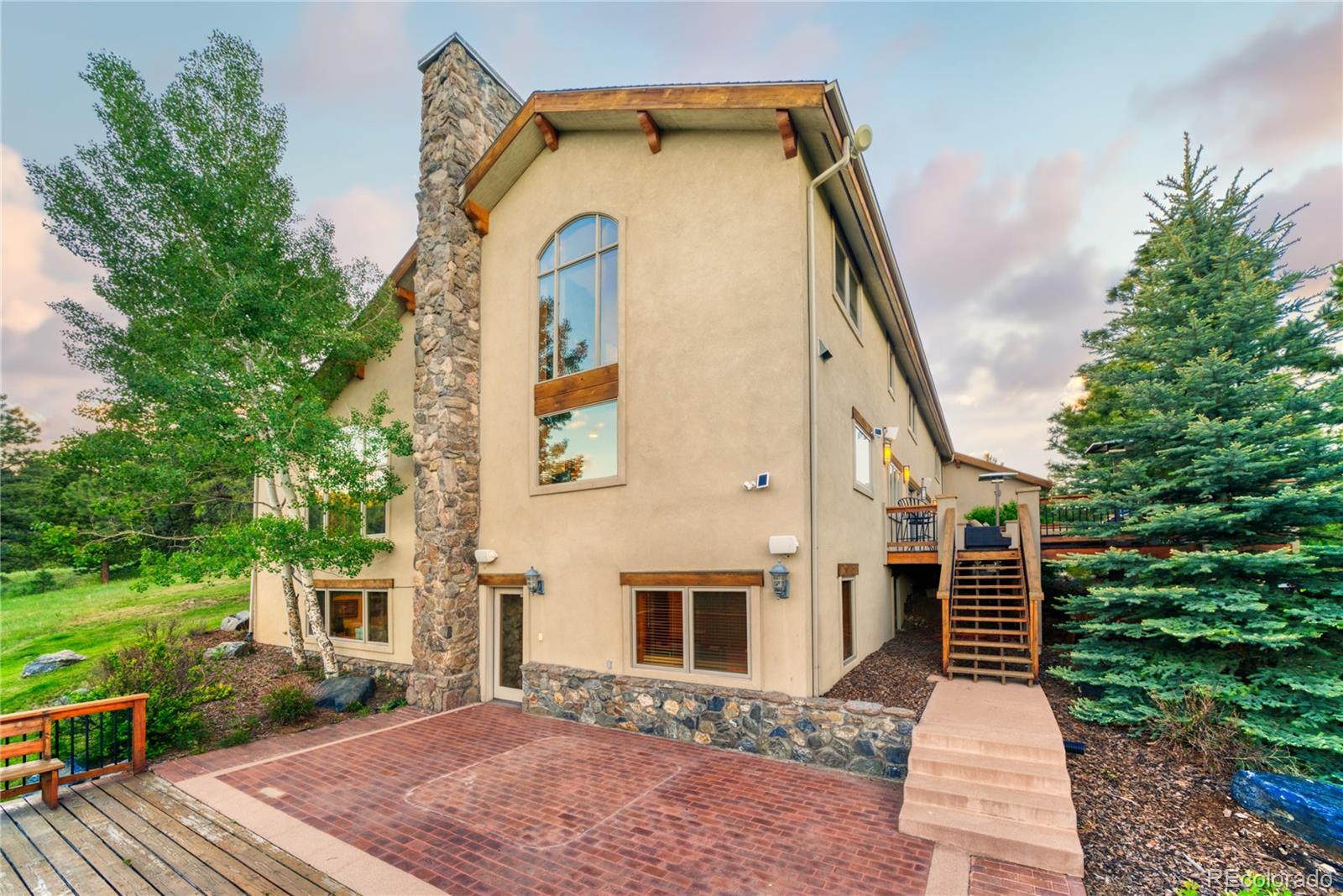 33231 Meadow Mountain Road Evergreen, CO 80439 - Photo 39 of 40 a front view of a house with garden