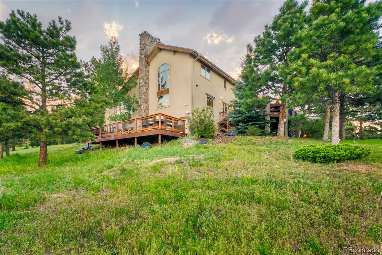 33231 Meadow Mountain Road Evergreen, CO 80439 - Photo 40 of 40 a front view of a house with garden