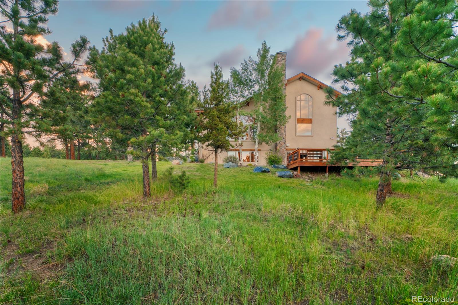 33231 Meadow Mountain Road Evergreen, CO 80439 - Photo 4 of 40 a view of a house with a backyard