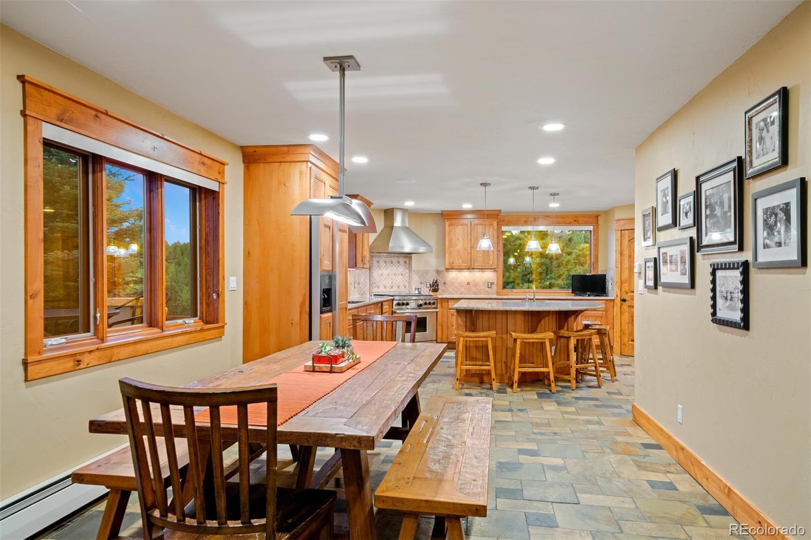33231 Meadow Mountain Road Evergreen, CO 80439 - Photo 9 of 40 a dining room with furniture a chandelier and wooden floor