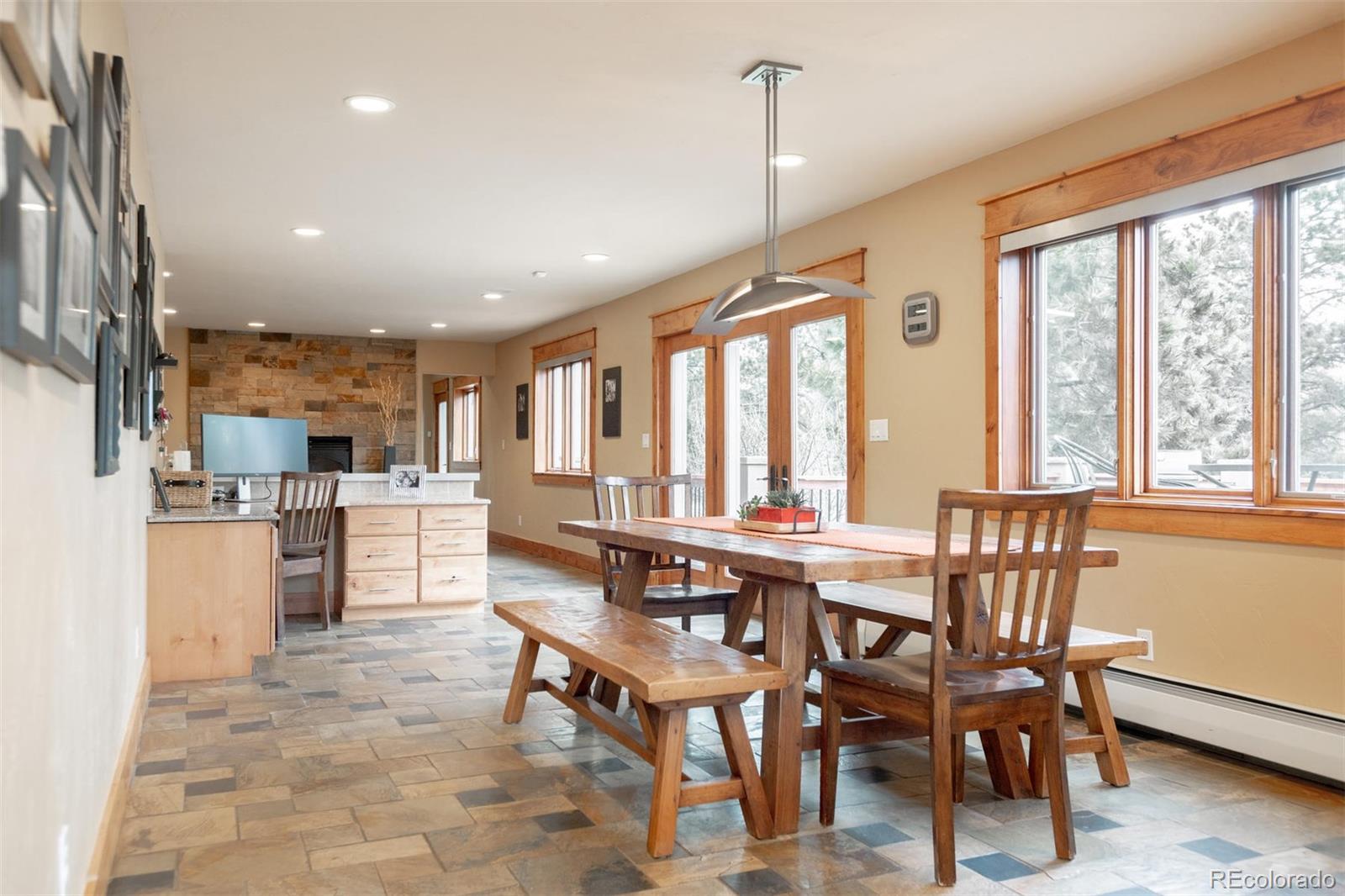 33231 Meadow Mountain Road Evergreen, CO 80439 - Photo 10 of 40 a view of a dining room with furniture window and wooden floor