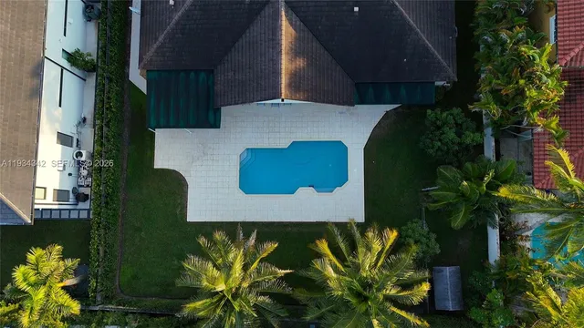 an aerial view of a house with garden space and signage
